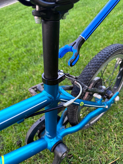 Blue bicycle with a wrench on a grassy background