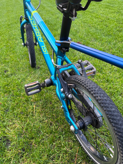 Blue children's bicycle on grass